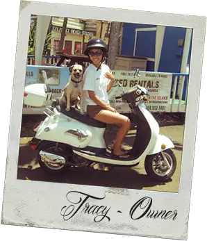 A woman on a scooter with a dog